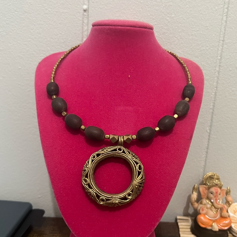 Brass metal and lotus beaded necklace.
